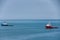 Red and blue tug boats on blue sea, Darwin, Australia.