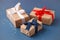 Red, blue and white gift boxes on classic blue background in the national colors of America, Russia, France or England, the