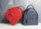 Red and blue woman backpacks