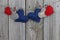 Red, blue and wood country hearts hanging on clothesline with wooden background