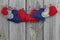 Red, blue and wood hearts hanging on clothesline with wood background