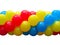 Red, blue and yellow celebration balloons in stack isolated