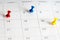 Red blue yellow pins on calendar