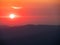 Red blurry sunrise time over Karkonosze mountains. Mist over the range. Poland