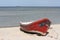 A red boat on a beach