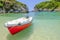 Red boat on the beach Paleokastritsa, Corfu, Greece.