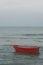 Red boat is floating in the sea