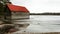 Red boat house on a frozen lake