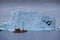 Red boat among icebergs in Disko Bay, West Greenland