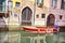 Red boat Venice scenic old streets water canal. Italian Lagoon