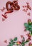 Red border of sparkly hearts, silk roses and cute ribbon on a soft pink background for Valentine`s Day in February. Vertical