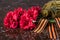 Red bouquet of flowers with a military jar and festive ribbons, on the background of marble