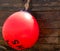 Red Bouy against a wooden boat