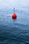 Red bouy on a calm lake