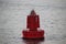 Red bouy on the Nieuwe Waterweg at the harbor of Rotterdam to mark the shipping route.