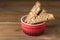 Red Bowl with Fresh Baked Biscotti Cantucci Italian Almond Sweets Biscuits Cookies Wooden Background Copy Space