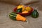 Red bowl of green and orange ornamental gourds