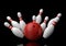 Red Bowling Ball and scattered white skittles isolated on black background