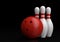 Red Bowling Ball and white skittles isolated on black background