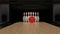 Red bowling ball on a wooden track with pins