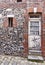 Red brick building with old rustic white wooden doors in Honfleur