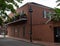 Red brick building with sign on the front representing the history