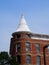 Red Brick Building With White Conical Roof