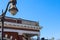 A red brick building with white marble trim with the word Douglasville on the top with a tall black curved light post