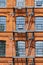 Red brick classic industrial building facade with fire escape ladder stairs