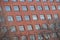 Red brick classic industrial building facade with multiple windows