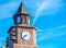 Red brick clock tower with bells