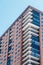 Red Brick Condos with White Balconies and Blue Windows