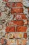 Red brick crumbled off wall wallpaper background backdrop