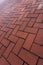 Red brick floor paving clinker brick in imperial format texture. Herringbone Brick clinker textures.