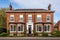 red brick georgian house with multi paned windows