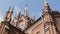 Red brick Gothic Church on background blue sky. Action. Bottom view of old Church in Gothic architectural style. Roman