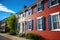 red brick home with blue shutters in broad daylight