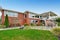 Red brick house with tile roof. Back yard