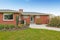 Red brick house with tile roof. Front view