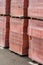 Red brick packed on the wooden pallets