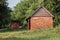 Red brick shed with wooden roof