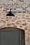 Red brick and stone building doorway arch with black barn light