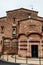 Red brick vintage building of Ca l`Ordal in La Colonia Guell in Barcelona, Spain