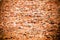 Red brick wall background:old weathered grungy red orange brick wall covered by cement and grey paint texture background