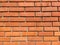 Red brick wall. Beautifully and neatly folded brick wall in sunlight