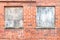 Red brick wall boarded up windows