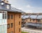 Red brick wall building exterior houses with glazed loggia fasade blue sky background.