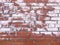 Red brick wall with damage paint