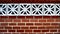 Red Brick Wall With Floral Detailed Concrete Blocks Close Up