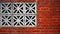 Red Brick Wall with Floral Patterned Concrete Blocks Close Up